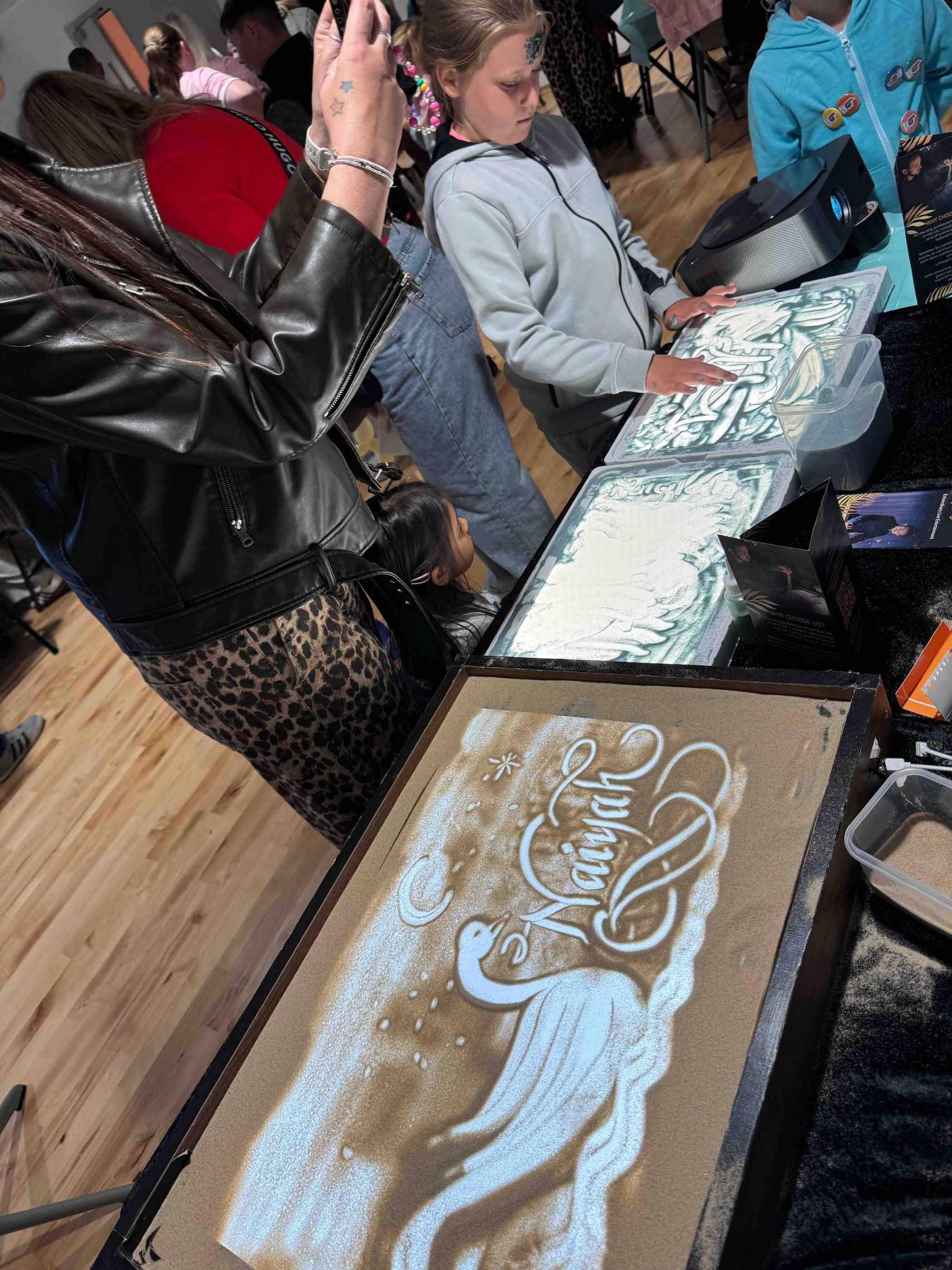 Pupils at a hands-on sand art workshop