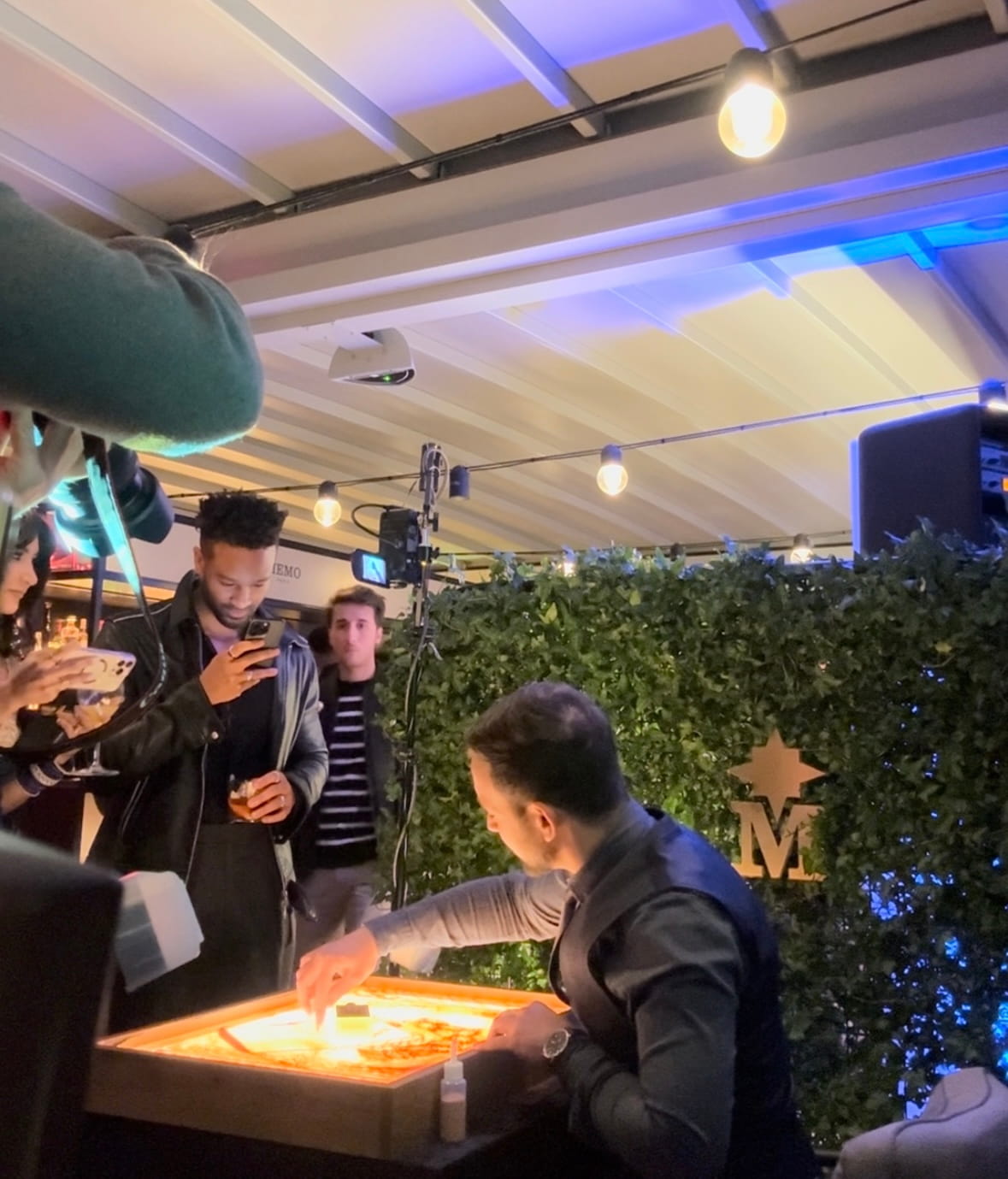 Guests watching a private sand art performance
